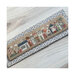 Photo of the finished pattern on a geometric fabric board laid on a wood grain floor.