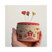 Photo of the Big-Hearted Tiny Town pattern finished on a pinkeep template being held against a white background.
