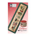 Front cover of the Christmas Tiny Town finished pattern isolated on a red-pink background.