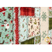 An angled close up on the quilt, demonstrating fabric prints, colors, and ragged details.