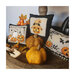 Photo of three Halloween Pillow designs surrounded by pumpkins, leaves, and fall berries.