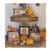 Photo of the four Halloween Pillow designs stacked on a tower of leaves, pumpkins, leaves, and Jack-o'-Lanterns.