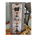 Enhanced photo of the finished Boo! cross stitch pattern leaning against a steel lantern next to yellow squash and maple leaves.