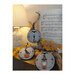 Photo of three of the finished Decorative Halloween Trio patterns finished in circular hoops resting on a branch with autumnal leaves, pumpkins, and music sheets.