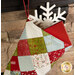 A close up shot of the top of the stocking, showcasing patchwork and the small loop to hang the stocking. A red gift box and a snowflake peek out of the top.