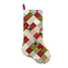 The completed Fast Fusible Patchwork Stocking colored in wintry prints from the Chilly collection by Moda Fabrics, isolated on a white background. 