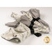 The four completed Cloth Napkins, tied with black bows and isolated on a white background. on a white background.