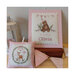 Photo of the finished patterns next to each other on a wood table accented with triangle garlands.