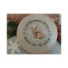 Finished pattern in a wooden hoop laid next to pinecones, pine boughs, and a snowflake.