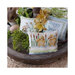 Photo of the bottom layer of the wooden tower holding the Chicks, Bunny, and Happy Spring pillows along with florals and eggs.