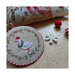 Angled photo with the finished patterns stitched onto a pillow on top of a wooden table.