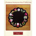 Round black wool table mat with colorful Christmas-themed appliqués, including Santa and ornaments.