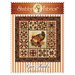 The finished Give Thanks quilt with an applique cornucopia in the center, surrounded by 12 pieced sampler blocks.