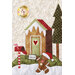 A whimsical quilted scene featuring a gingerbread man wearing a Santa hat, standing in front of a gingerbread house. The house has a heart-shaped window and a snow-covered roof. A red mailbox holds a letter to Santa, with a green tree in the background.