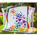 The beautiful Blooming Butterflies quilt draped over a chair outside | Shabby Fabrics