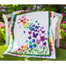 The beautiful Blooming Butterflies quilt draped over a chair outside