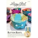 A colorful sewing pattern titled Button Boats by Lazy Girl Designs, featuring a variety of small fabric storage baskets in vibrant colors and patterns. The design includes buttons and folds for easy assembly. The packaging includes information for using the pattern to create the baskets.