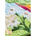 Applique of three white lilies with embroidered stamen and pistil.