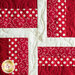 The first red and white block in the Learn to Quilt Beginner Quilt