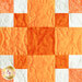 The second orange and white block in the Learn to Quilt Beginner Quilt