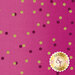 A pink fabric background with various-sized dots in dark purple and gold scattered throughout.