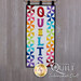 Quilts Wall Hanging with two rows of pinwheels in a rainbow of colors. Appliqued text reads Quilts.