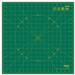 Green cutting mat with a grid pattern, marked circles, and measurement guides along the edges.