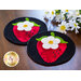 Two round coasters featuring red strawberries with white flowers and green leaves, set on a black background. Daisies are blurred in the background, and a logo for Shabby Fabrics is visible in the corner.