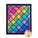 A colorful quilt featuring a diamond pattern with vibrant hues including shades of pink, orange, yellow, blue, and green, set against a black background. Each diamond showcases floral or patterned fabric, creating a lively design. A logo is displayed in the bottom corner.