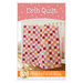 Front cover of Crib Quilt pattern, with patchwork quilt draped over edge of crib