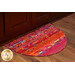 A brightly colored, half-oval area rug with a vibrant pattern of reds, pinks, and multicolored designs, placed near wooden cabinetry.