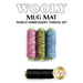 Four spools of embroidery thread in pink, green, and blue shades are displayed above a black spool, with the text Wooly Mug Mat March Embroidery Thread Set and a logo for Shabby Fabrics below.