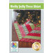 A decorative tree skirt named Holly Jolly Tree Skirt, featuring a patchwork design in red, green, and white geometric patterns. The skirt is placed beneath a Christmas tree with twinkling lights.