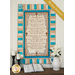 Cream, beige, and aqua colored quilt featuring a script of the Amazing Grace, hung on a cream paneled wall and staged with a bible and coordinating decor.