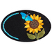 An embroidered oval patch featuring a bright yellow sunflower with a dark center and green leaves, accompanied by a blue butterfly resting on one of the petals. A decorative blue swirl is present on the left side of the patch against a black background.