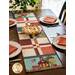 A colorful table runner with an American flag and school on a dark wooden table.