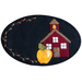 The completed September Wooly Mug Mat with a schoolhouse and yellow apple on the right with a berry and leaf embroidered edge, isolated on a white background.