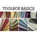 A collection of fabric swatches in various colors and patterns, labeled Toolbox Basics by Marcus Fabrics. The fabrics are arranged in rows, showcasing a variety of hues including browns, yellows, greens, and purples, some with small checks.