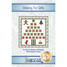 A decorative wall hanging design for an Advent calendar featuring a Christmas tree made of numbered pockets, with a gingerbread man, Christmas trees, ornaments, stockings, and a gift. The top portion includes the text Wishing for Gifts.