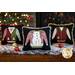 Three ugly sweater pillows displayed on a snow covered table