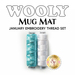 Wooly Mug Mat January Embroidery Thread Set featuring two spools of thread in aqua and white isolated on a white background.