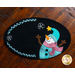 Overhead view of black mug mat with snowman