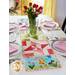 The adorable March Easy Pieced Table Runner displayed on a set table.