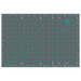 Cutting mat with grid lines in teal on a gray background, featuring measurement markings and angles.