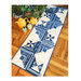 A blue and white quilted table runner laid on a wooden floor, with yellow teapots and a green teacup.