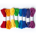 A row of eight elastic cords in various colors: red, yellow, green, blue, purple, and violet, each secured with a white band.