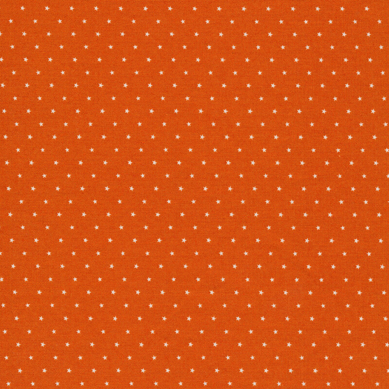 Fabric featuring white stars on an orange background