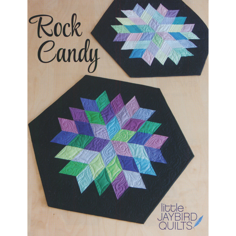 Two hexagonal quilted table toppers in pastel colors, titled Rock Candy, on a light wooden background.