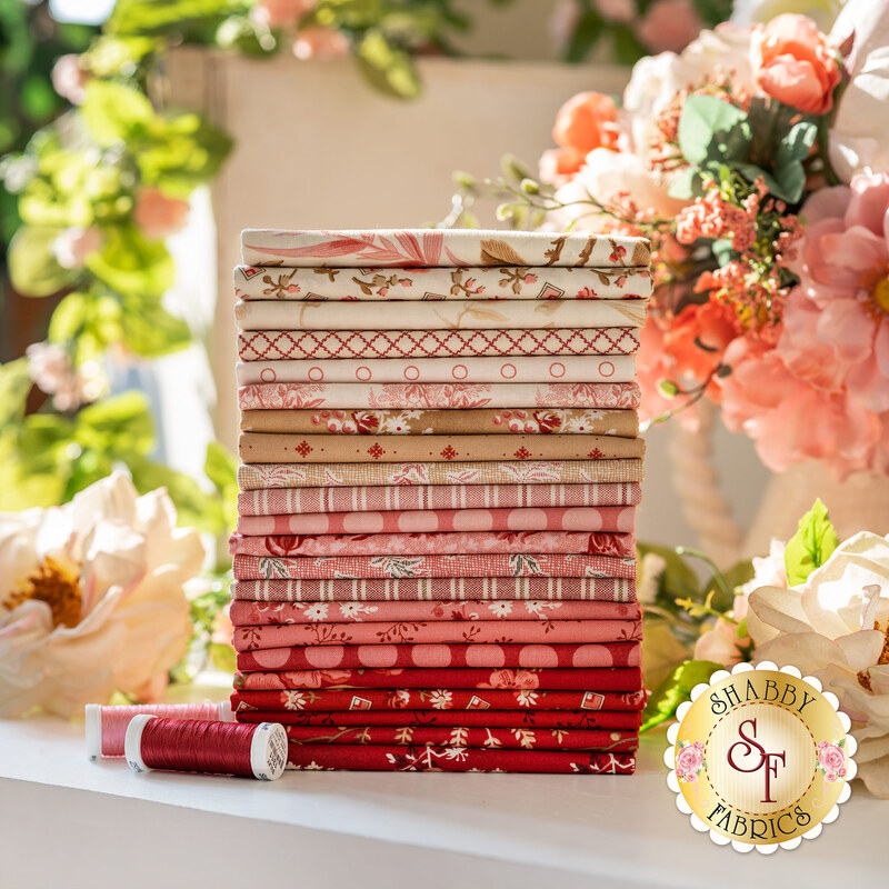 Photograph of the neatly stacked little sweetheart collection, consisting of cream, pink, tan, and red fabrics