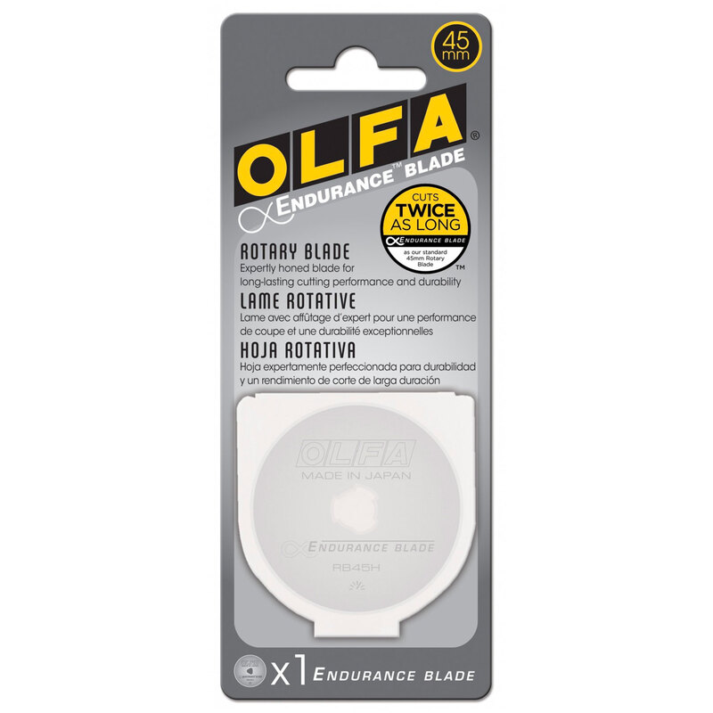 Packaging for an OLFA 45mm endurance rotary blade, highlighting durability and cutting performance, and containing a plastic carry case with a blade in it.